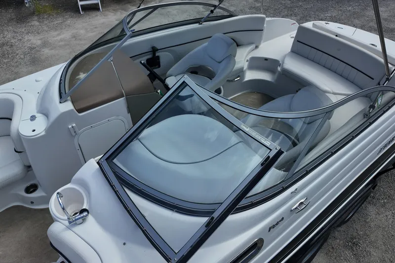 Slide: The Image of 2009 Four Winns F224 boat interior with seating and windshield, showcasing luxury design. - 10