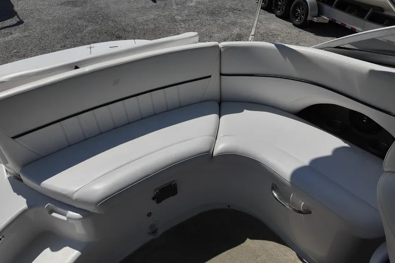 Slide: The Image of 2009 Four Winns F224 boat interior with white cushioned seating and sleek design. - 21