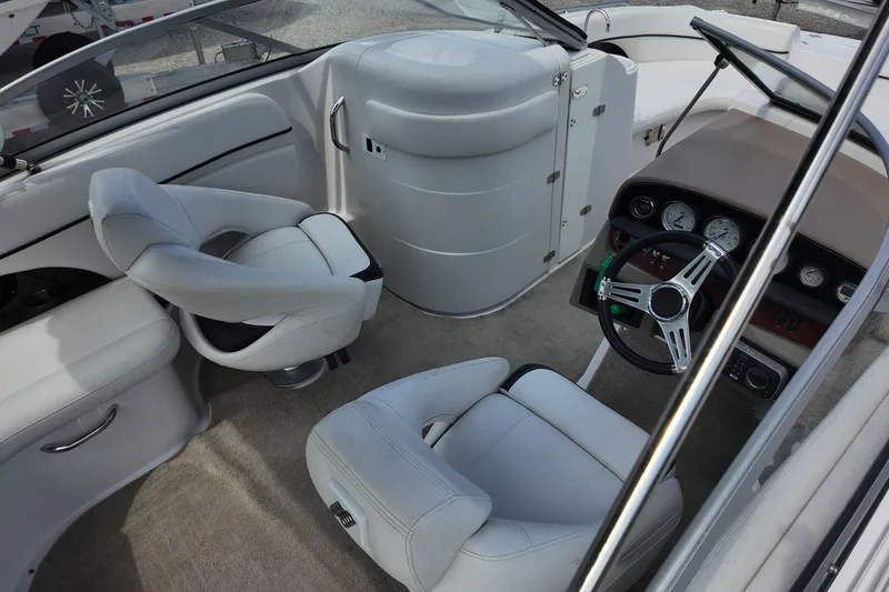 Slide: The Image of Interior of a 2009 Four Winns F224 boat featuring steering wheel and seating. - 6