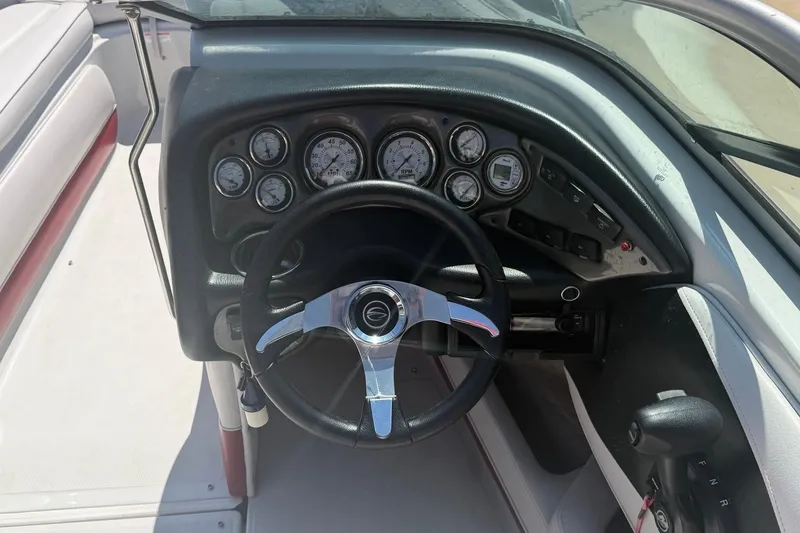 Slide: The Image of Steering wheel and dashboard of a 2013 Crownline 21 SS boat. - 7