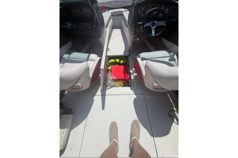 Slide: The Image of Interior view of a 2013 Crownline 21 SS boat, featuring seating and storage compartments. - 9