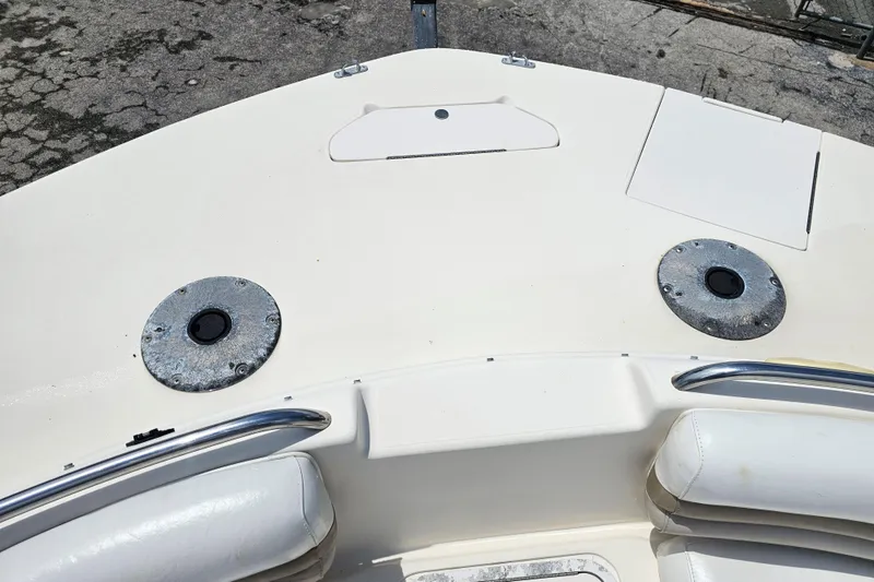 Slide: The Image of 2006 Hurricane SunDeck 237 DC OB boat deck with seating and metal fixtures. - 11