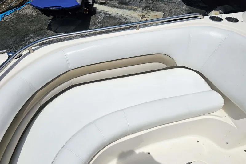 Slide: The Image of 2006 Hurricane SunDeck 237 DC OB boat with white cushioned seating. - 14