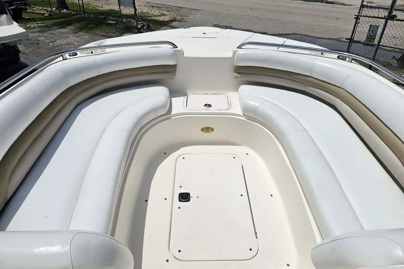 Slide: The Image of 2006 Hurricane SunDeck 237 DC OB boat with spacious white seating area. - 12