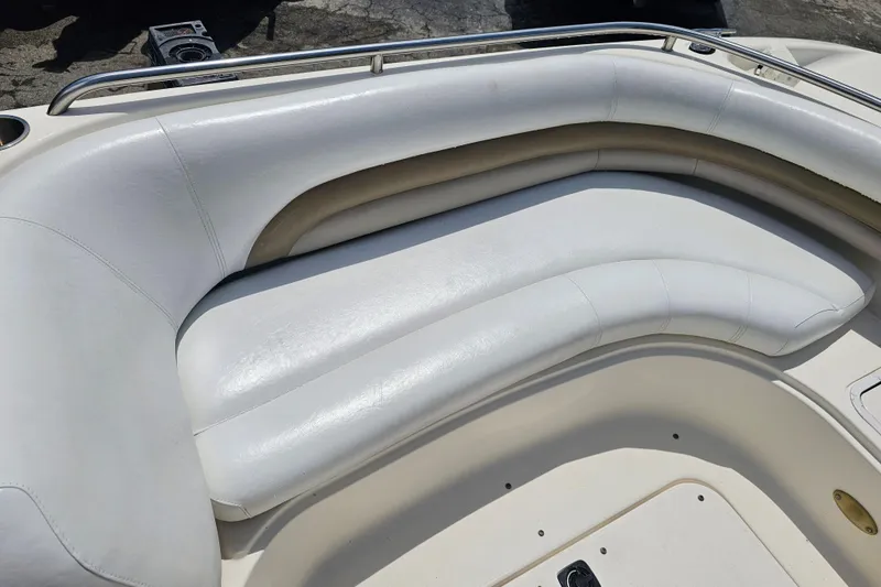 Slide: The Image of 2006 Hurricane SunDeck 237 DC OB boat with white cushioned seating and stainless steel railing. - 13