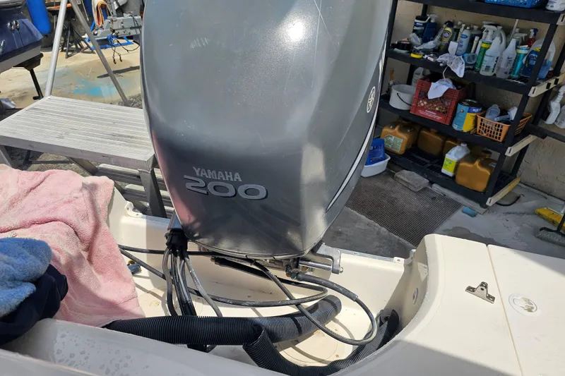 Slide: The Image of 2006 Hurricane SunDeck 237 DC OB with Yamaha 200 outboard motor in maintenance area. - 27