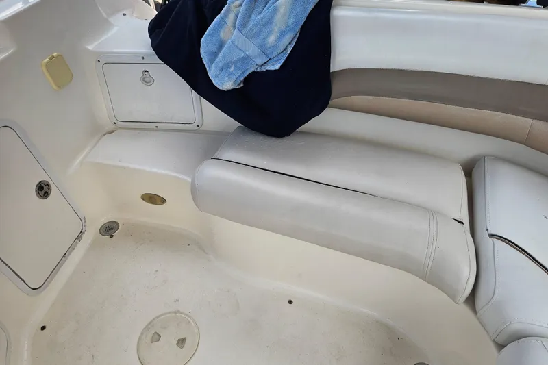 Slide: The Image of 2006 Hurricane SunDeck 237 DC OB boat interior with seating and storage compartments. - 22