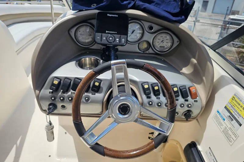 Slide: The Image of 2006 Hurricane SunDeck 237 DC OB boat dashboard with steering wheel and control panel. - 18
