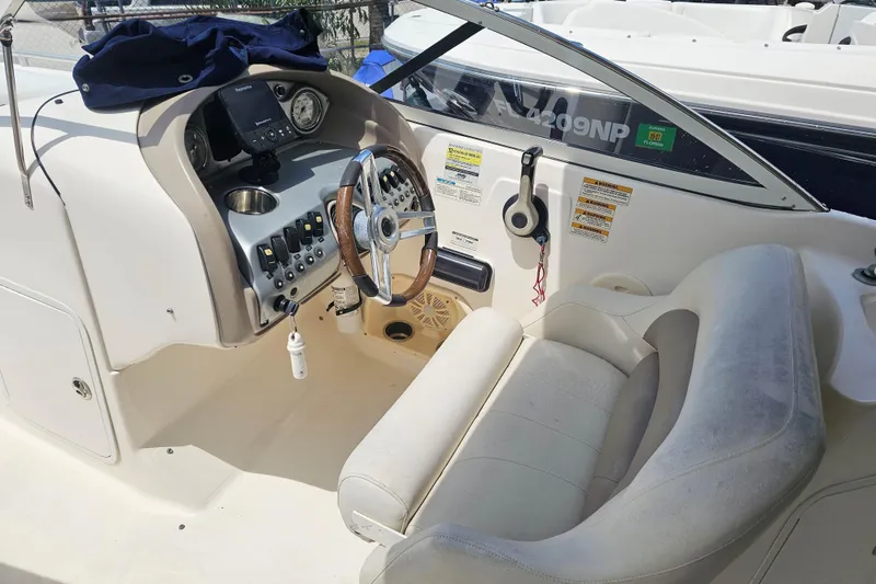 Slide: The Image of 2006 Hurricane SunDeck 237 DC OB boat cockpit with steering wheel and control panel. - 17