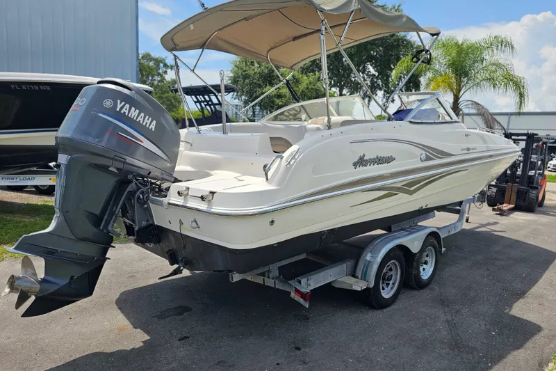 Slide: The Image of 2006 Hurricane SunDeck 237 DC OB boat with Yamaha outboard motor on trailer. - 8