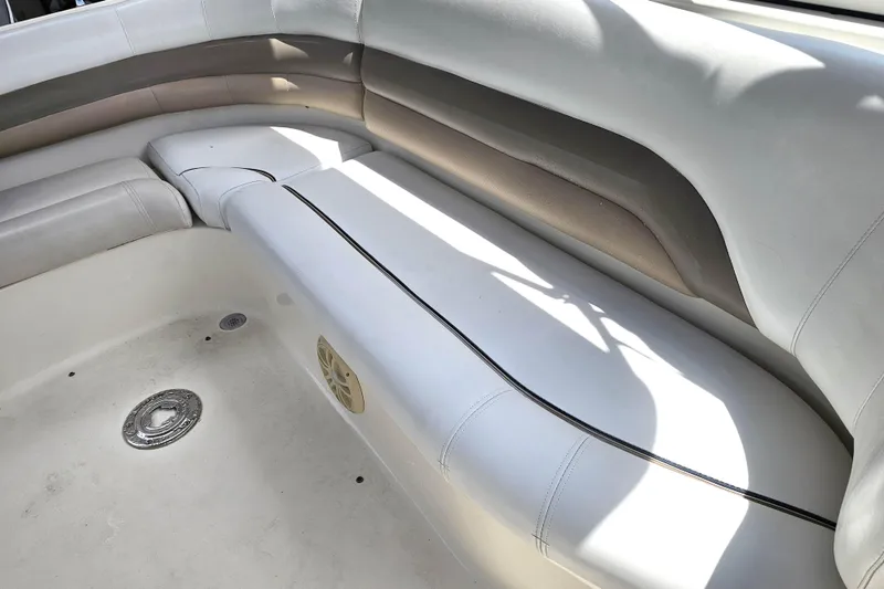 Slide: The Image of Interior seating of 2006 Hurricane SunDeck 237 DC OB boat, featuring white upholstery. - 21