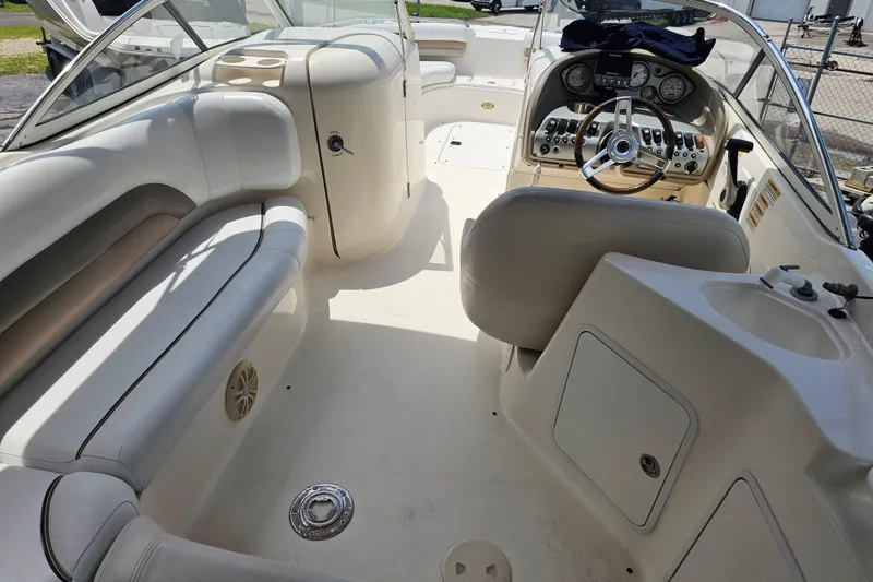 Slide: The Image of 2006 Hurricane SunDeck 237 DC OB boat interior with steering console and seating area. - 10