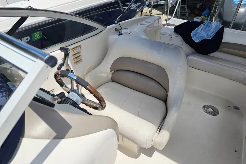 Slide: The Image of 2006 Hurricane SunDeck 237 DC OB boat interior with steering wheel and seating area. - 16