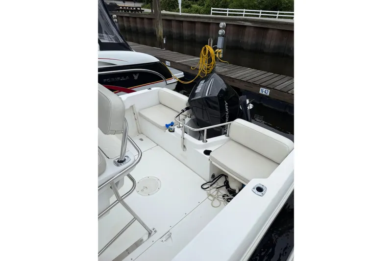 Slide: The Image of Boston Whaler 21 Outrage 2001 boat interior with seating and Mercury outboard motor. - 10