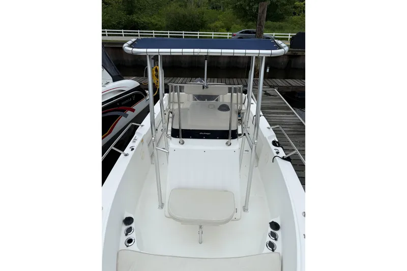 Slide: The Image of 2001 Boston Whaler 21 Outrage boat with T-top and center console, docked at marina. - 13