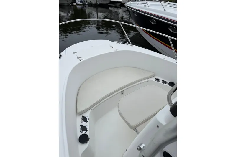 Slide: The Image of 2001 Boston Whaler 21 Outrage boat interior with cushioned seating and cup holders. - 14
