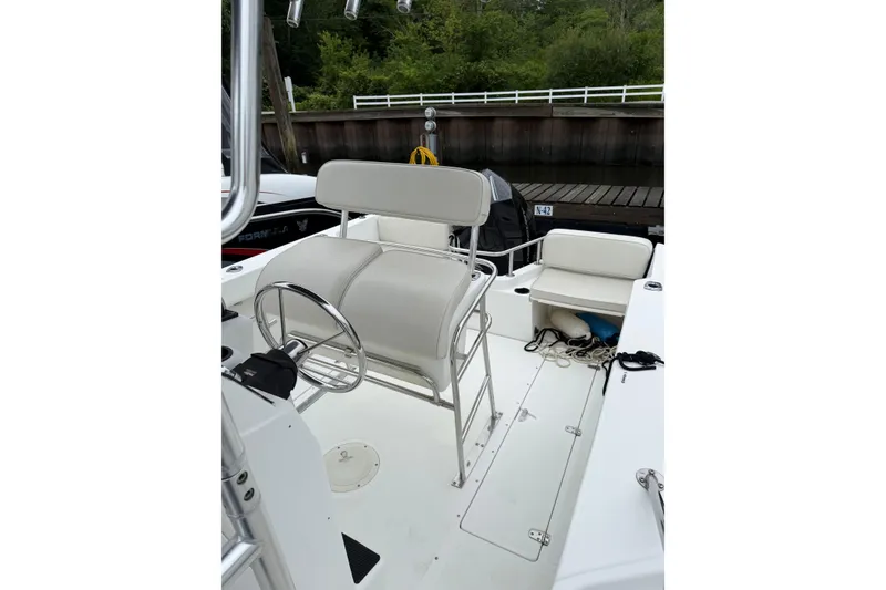 Slide: The Image of 2001 Boston Whaler 21 Outrage boat interior with steering wheel and seating. - 11