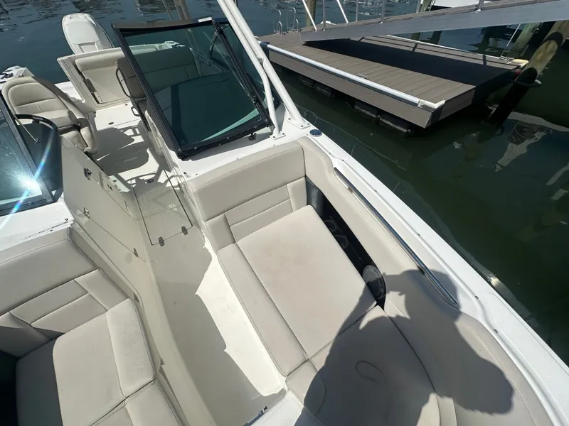 Slide: The Image of The image shows the cockpit of a 2018 Boston Whaler 230 Vantage with beige seating. - 19