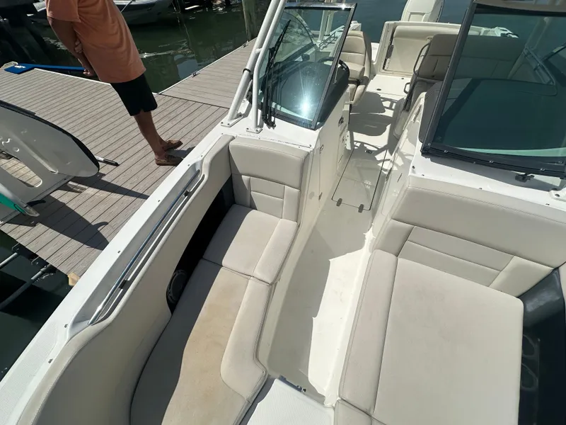 Slide: The Image of The image shows the cockpit of a 2018 Boston Whaler 230 Vantage with beige seating. - 20