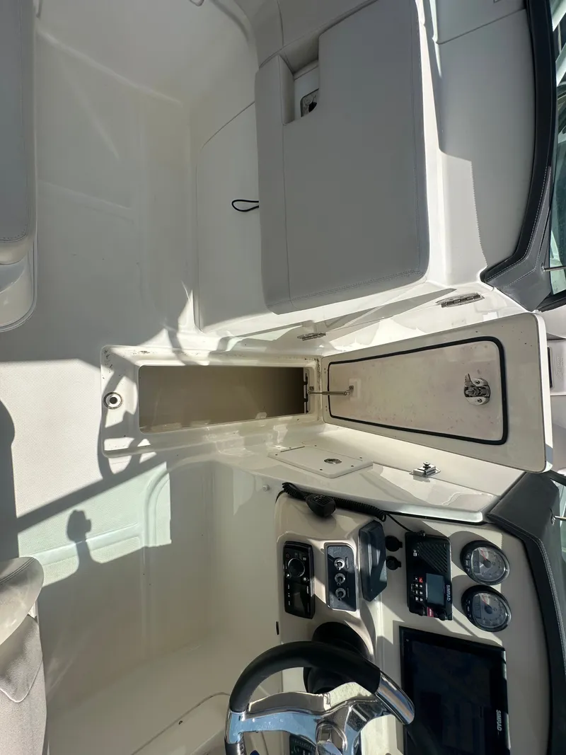 Slide: The Image of The image shows the cockpit of a 2018 Boston Whaler 230 Vantage with steering and instruments. - 24