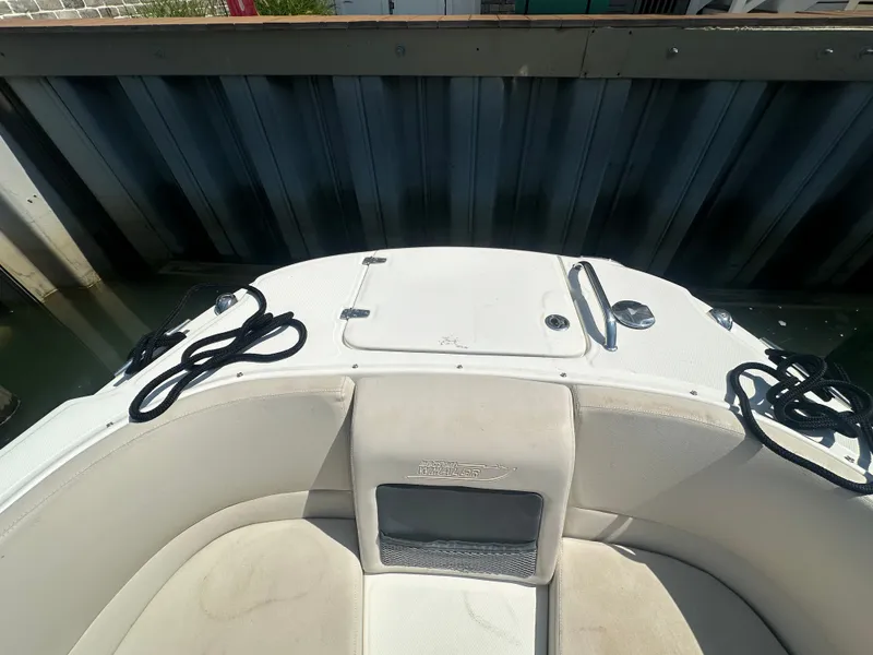 Slide: The Image of The image shows the bow of a 2018 Boston Whaler 230 Vantage boat docked at a pier. - 22
