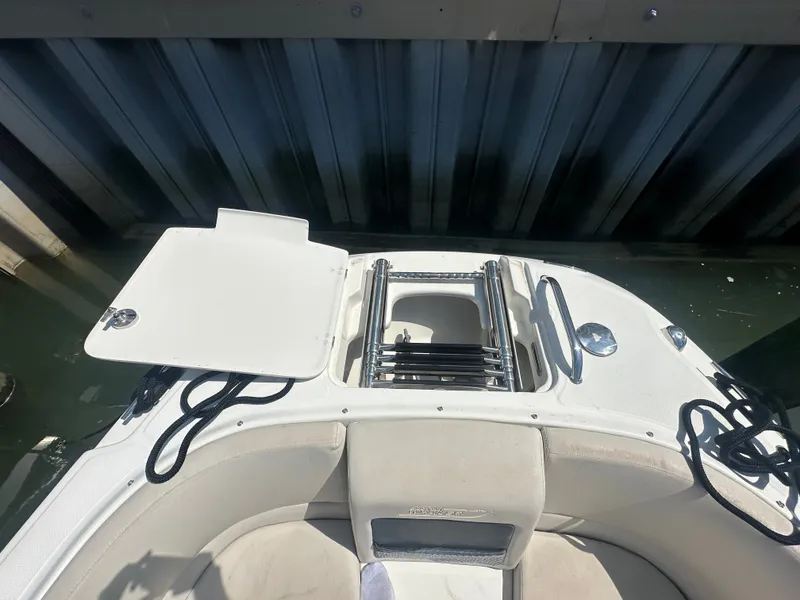 Slide: The Image of The image shows the stern of a 2018 Boston Whaler 230 Vantage with a foldable swim ladder. - 23