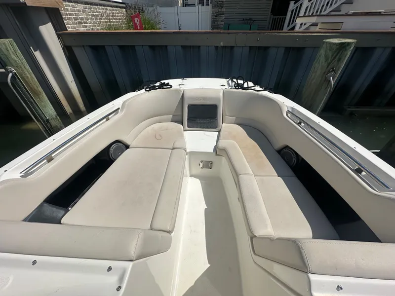 Slide: The Image of The image shows the bow area of a 2018 Boston Whaler 230 Vantage with beige upholstery. - 18
