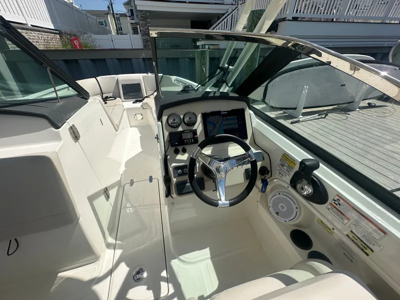 Slide: The Image of The cockpit of a 2018 Boston Whaler 230 Vantage with modern steering and instruments. - 13