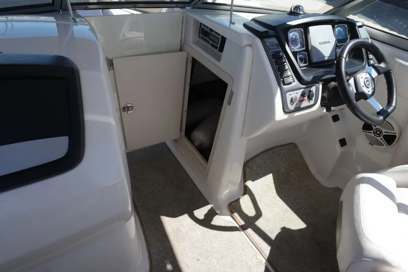 Slide: The Image of The image shows the cockpit of a 2008 Chaparral 264 Sunesta with a Garmin navigation system. - 5