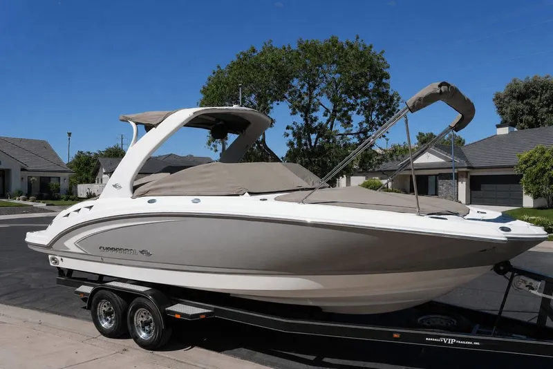 Slide: The Image of 2008 Chaparral 264 Sunesta on a trailer, with gray cover, parked in a residential area. - 34