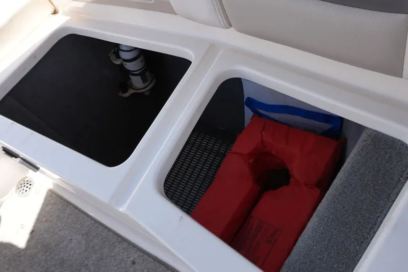 Slide: The Image of The image shows two storage compartments on a boat, one containing a red flotation device. - 23