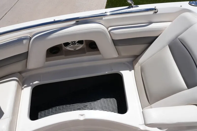 Slide: The Image of The image shows the seating area of a 2008 Chaparral 264 Sunesta boat with white upholstery. - 22