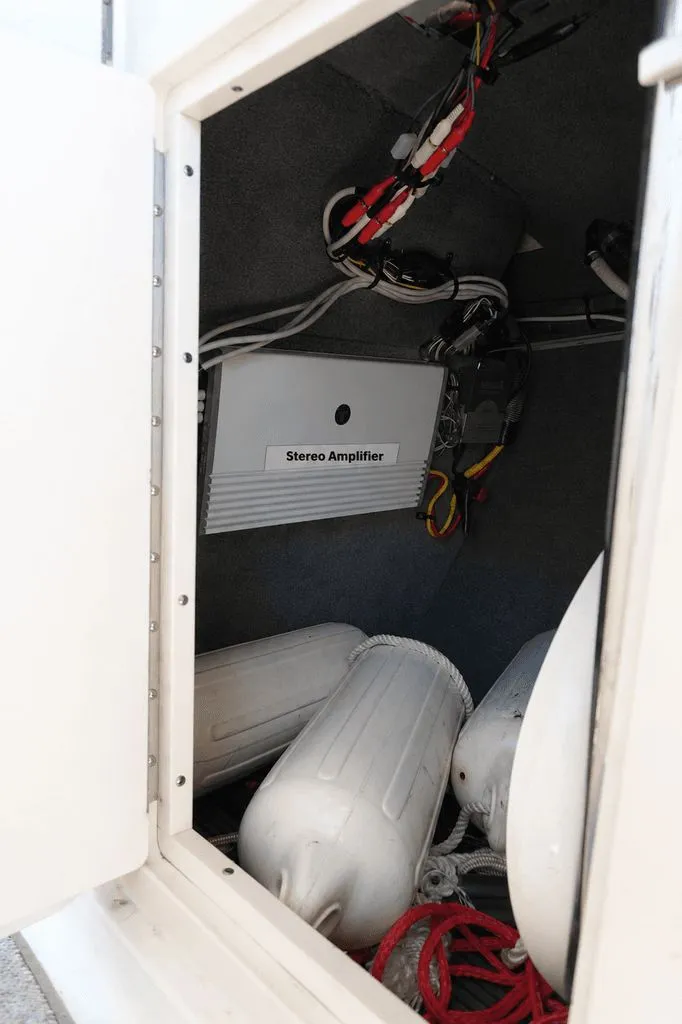 Slide: The Image of A storage compartment with a stereo amplifier and several fenders inside. - 27