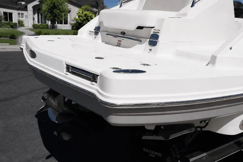 Slide: The Image of The image shows the rear of a white 2008 Chaparral 264 Sunesta boat on a trailer. - 32
