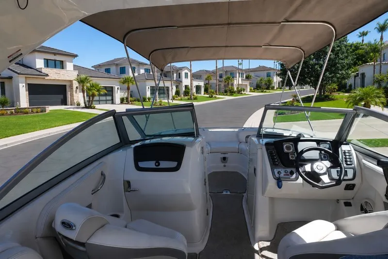 Slide: The Image of The image shows the cockpit of a 2008 Chaparral 264 Sunesta boat in a residential area. - 4
