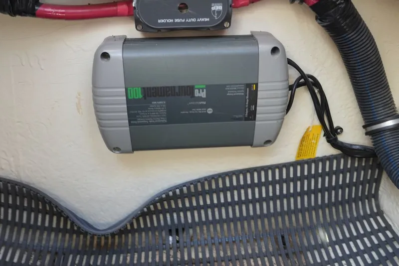 Slide: The Image of An electrical device is mounted on a boat wall, surrounded by cables. - 17