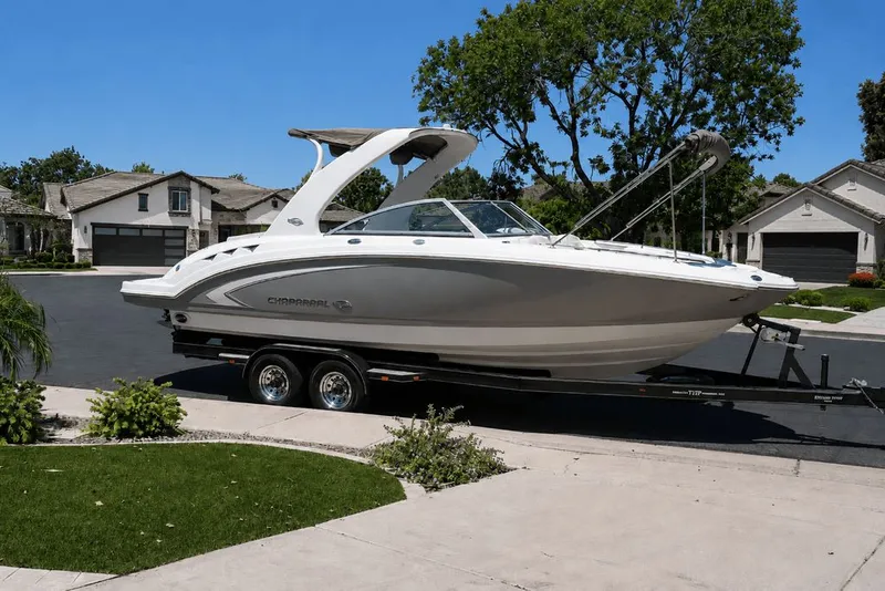 Slide: The Image of A 2008 Chaparral 264 Sunesta boat on a trailer in a residential neighborhood. - 35