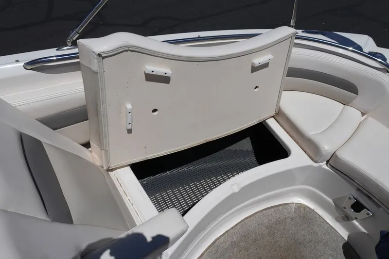 Slide: The Image of The image shows the bow area of a 2008 Chaparral 264 Sunesta boat with storage space. - 28