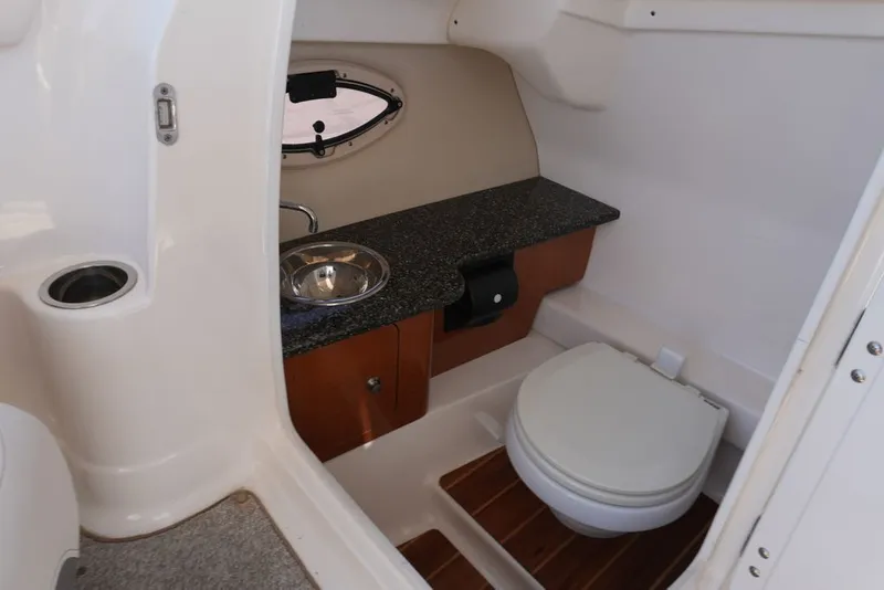 Slide: The Image of The image shows a boat cabin with a toilet, sink, and small window. - 18