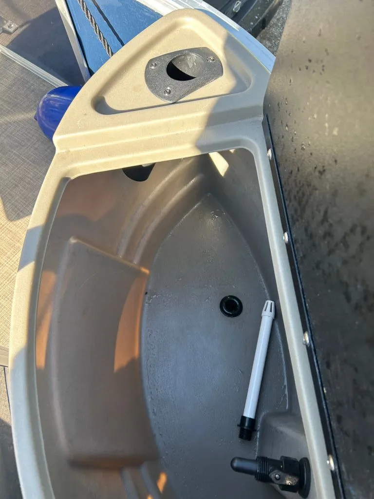Slide: The Image of A view of the interior of a 2023 Sun Tracker Bass Buggy with storage space and accessories. - 13
