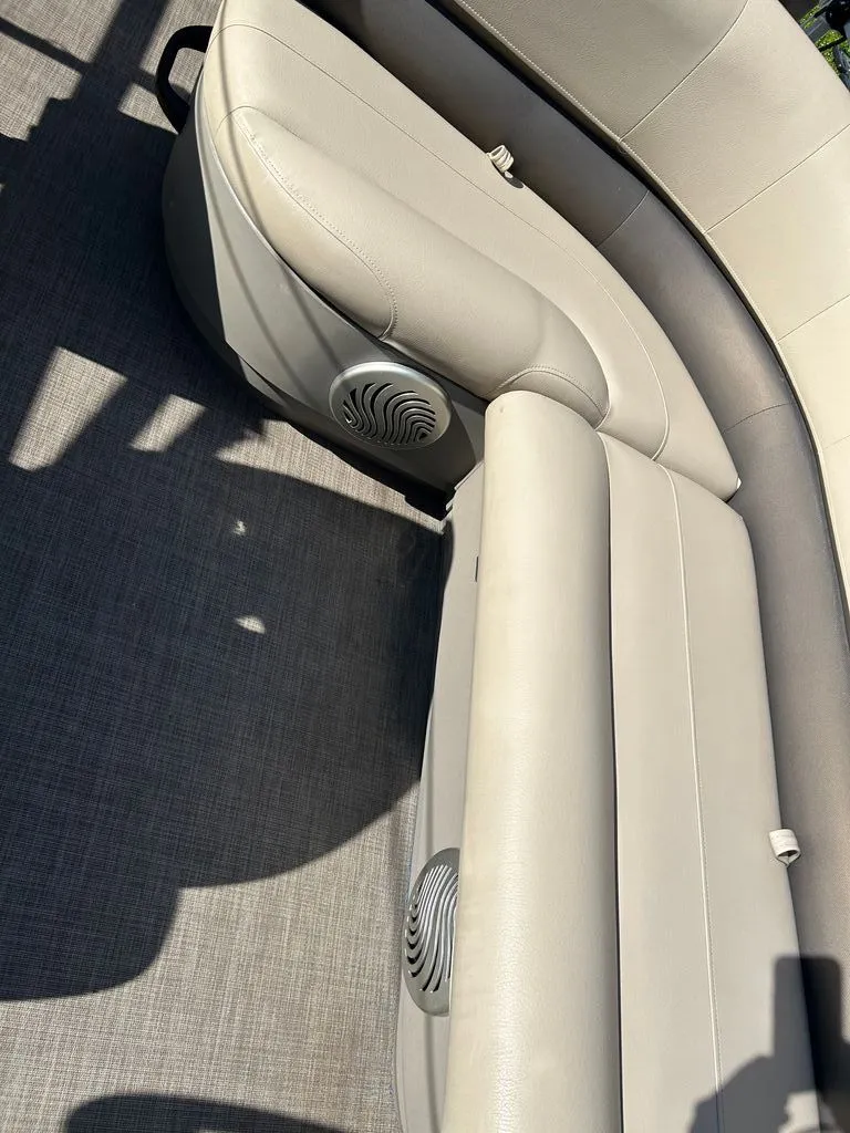 Slide: The Image of The image shows the cushioned seats of a 2023 Sun Tracker Bass Buggy with built-in speakers. - 9