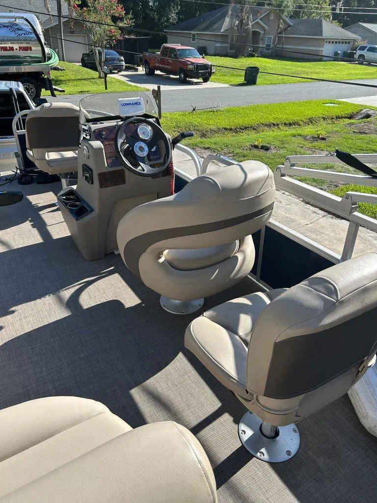 Slide: The Image of The image shows the cockpit of a 2023 Sun Tracker Bass Buggy with beige seats and a steering wheel. - 6