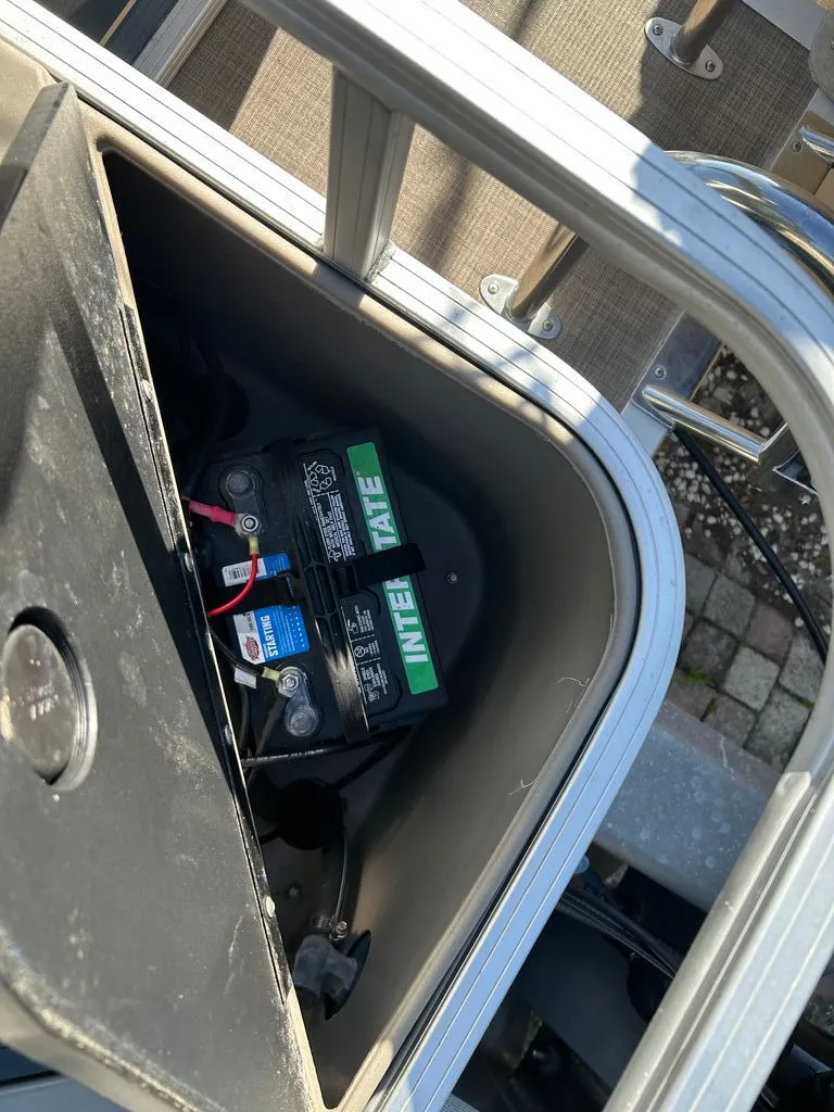 Slide: The Image of Battery in a storage compartment of a 2023 Sun Tracker Bass Buggy boat. - 14