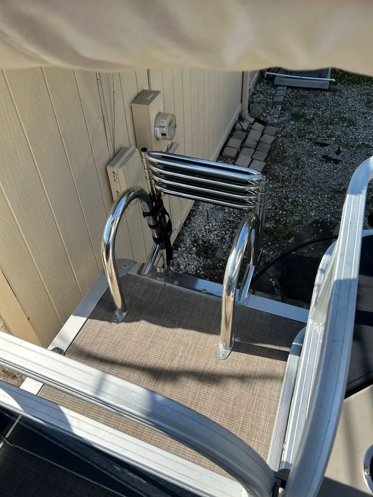 Slide: The Image of A metal swim ladder on a boat, surrounded by a carpeted deck. - 15