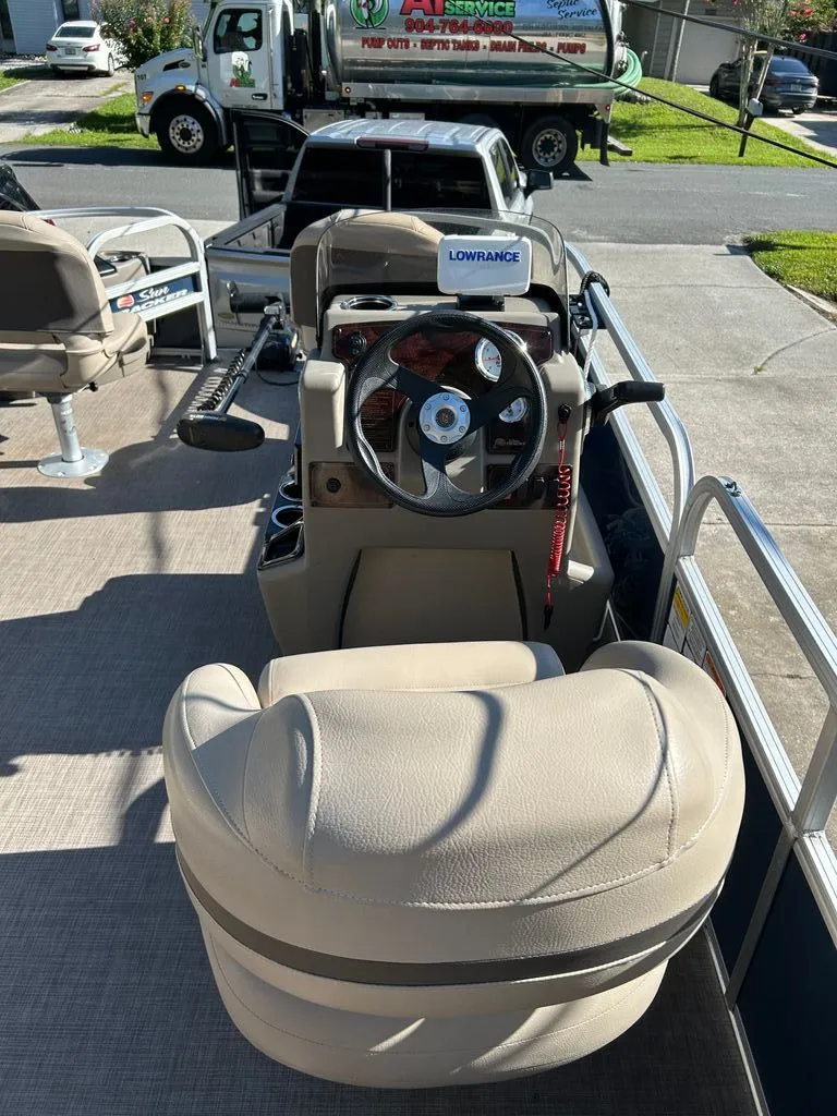 Slide: The Image of The image shows the cockpit of a 2023 Sun Tracker Bass Buggy with a beige captain's chair and steering wheel. - 5