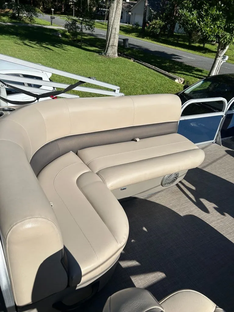 Slide: The Image of The image shows the beige seating of a 2023 Sun Tracker Bass Buggy. - 8