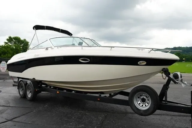 Slide: The Image of 2002 Rinker 276 Captiva Cuddy boat on trailer, parked outdoors under cloudy sky. - 3