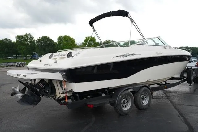 Slide: The Image of 2002 Rinker 276 Captiva Cuddy boat on trailer, parked outdoors. - 5