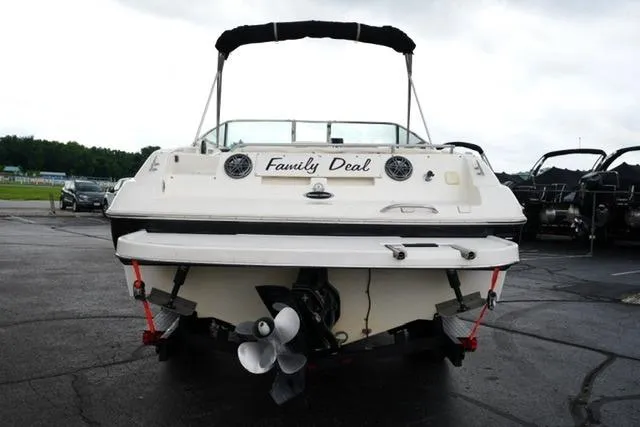Slide: The Image of 2002 Rinker 276 Captiva Cuddy boat, rear view, parked on asphalt. - 6