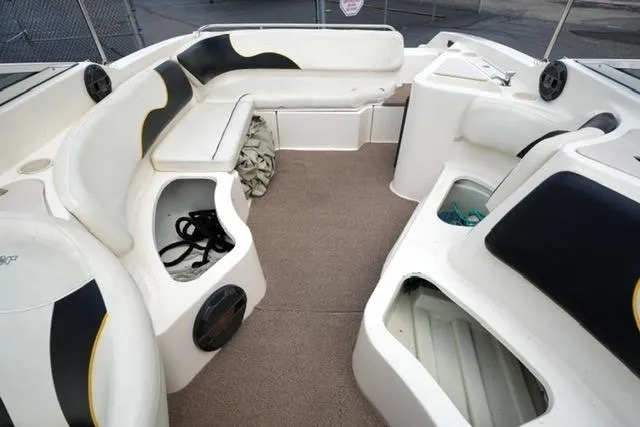 Slide: The Image of 2002 Rinker 276 Captiva Cuddy boat interior with seating and storage compartments. - 13